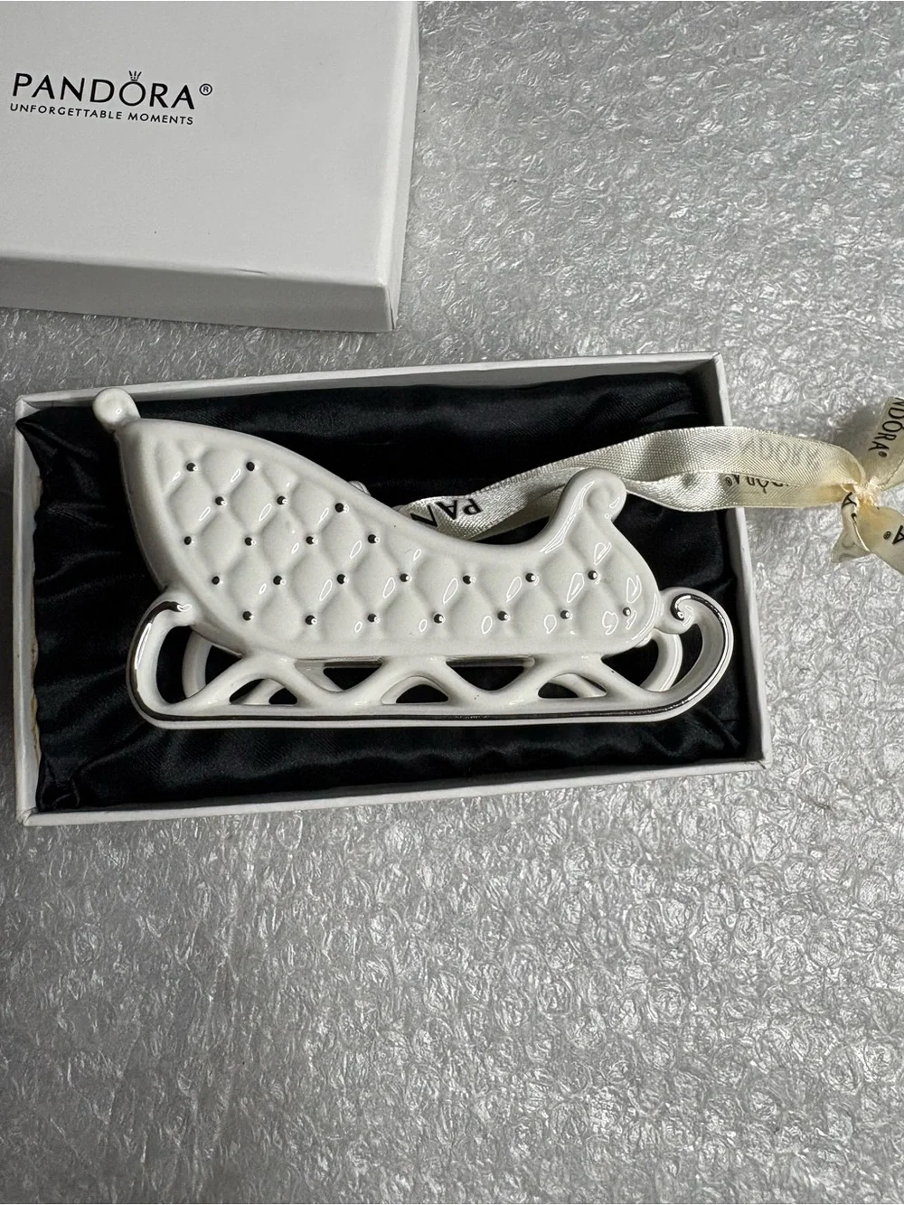 Pandora white porcelain sleigh ornament